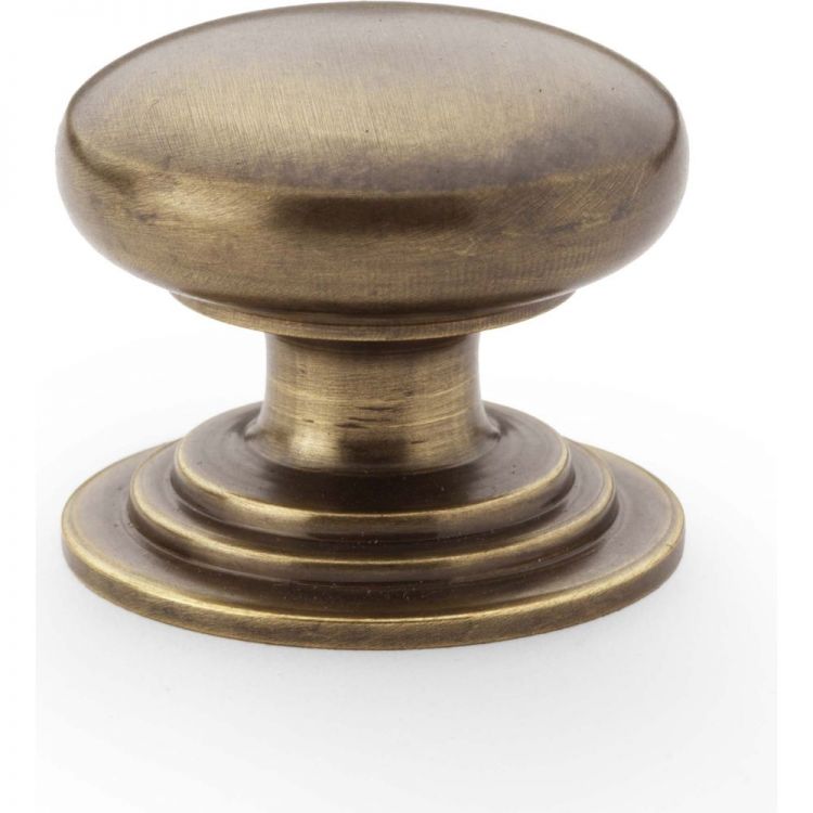 Waltz Round Cupboard Knob on Stepped Rose 32mm in Antique Brass - by Alexander & Wilks - AW825-32-AB
